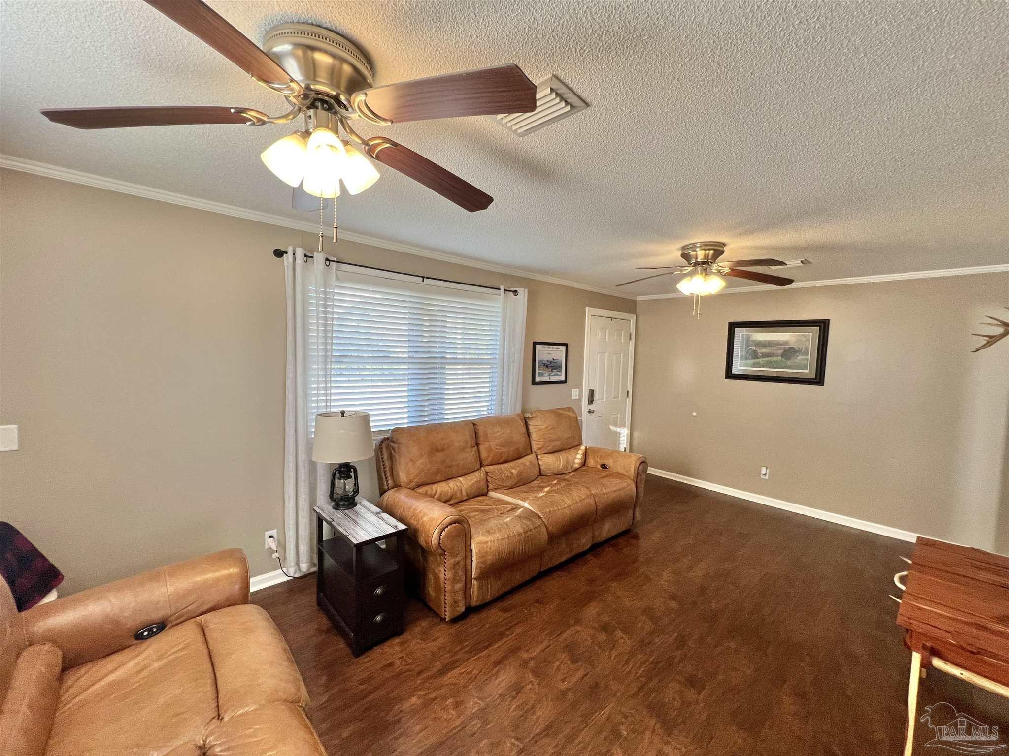 4075 Macks Road Century, FL 32535 - Photo 14 of 45 a living room with furniture and a chandelier
