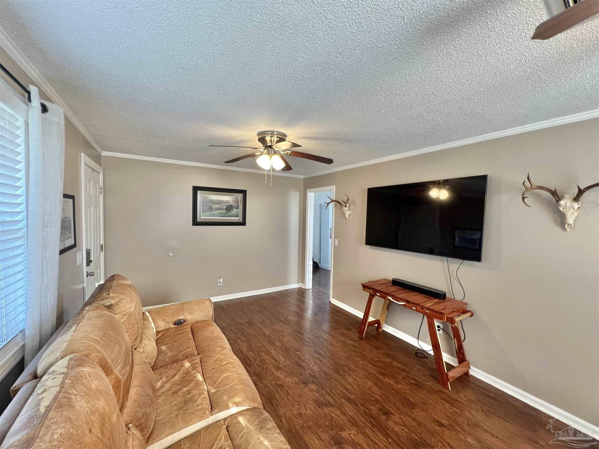 4075 Macks Road Century, FL 32535 - Photo 15 of 45 a living room with furniture and a flat screen tv
