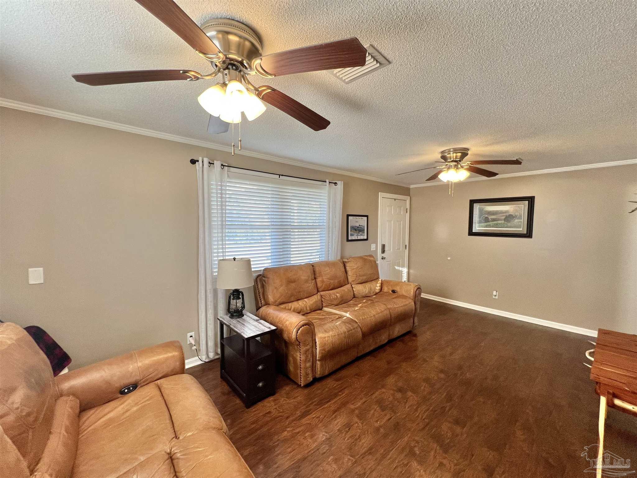 4075 Macks Road Century, FL 32535 - Photo 17 of 45 a living room with furniture and a chandelier
