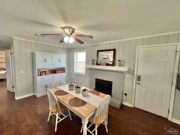 a dining room with furniture a fireplace and wooden floor