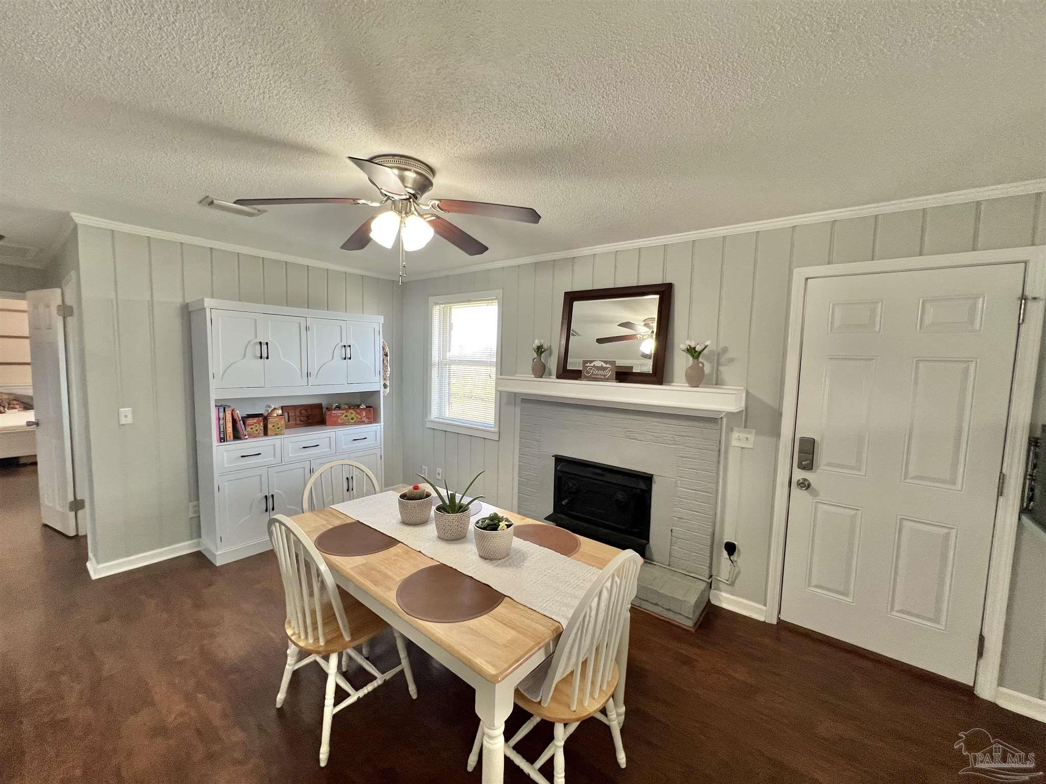 4075 Macks Road Century, FL 32535 - Photo 2 of 45 a dining room with furniture a fireplace and wooden floor