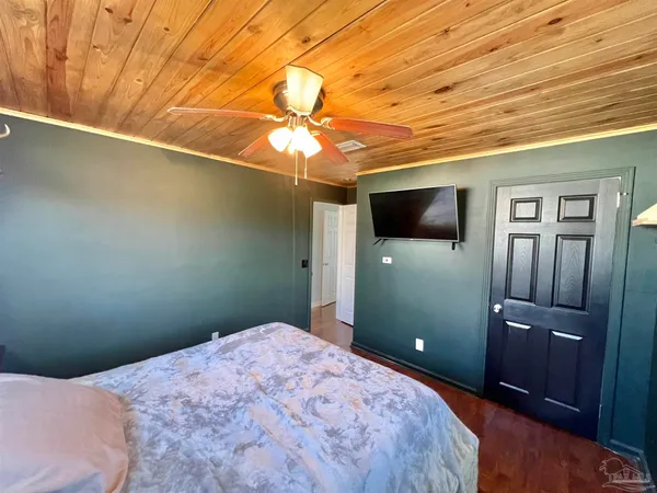 a bedroom with a bed and a flat screen tv