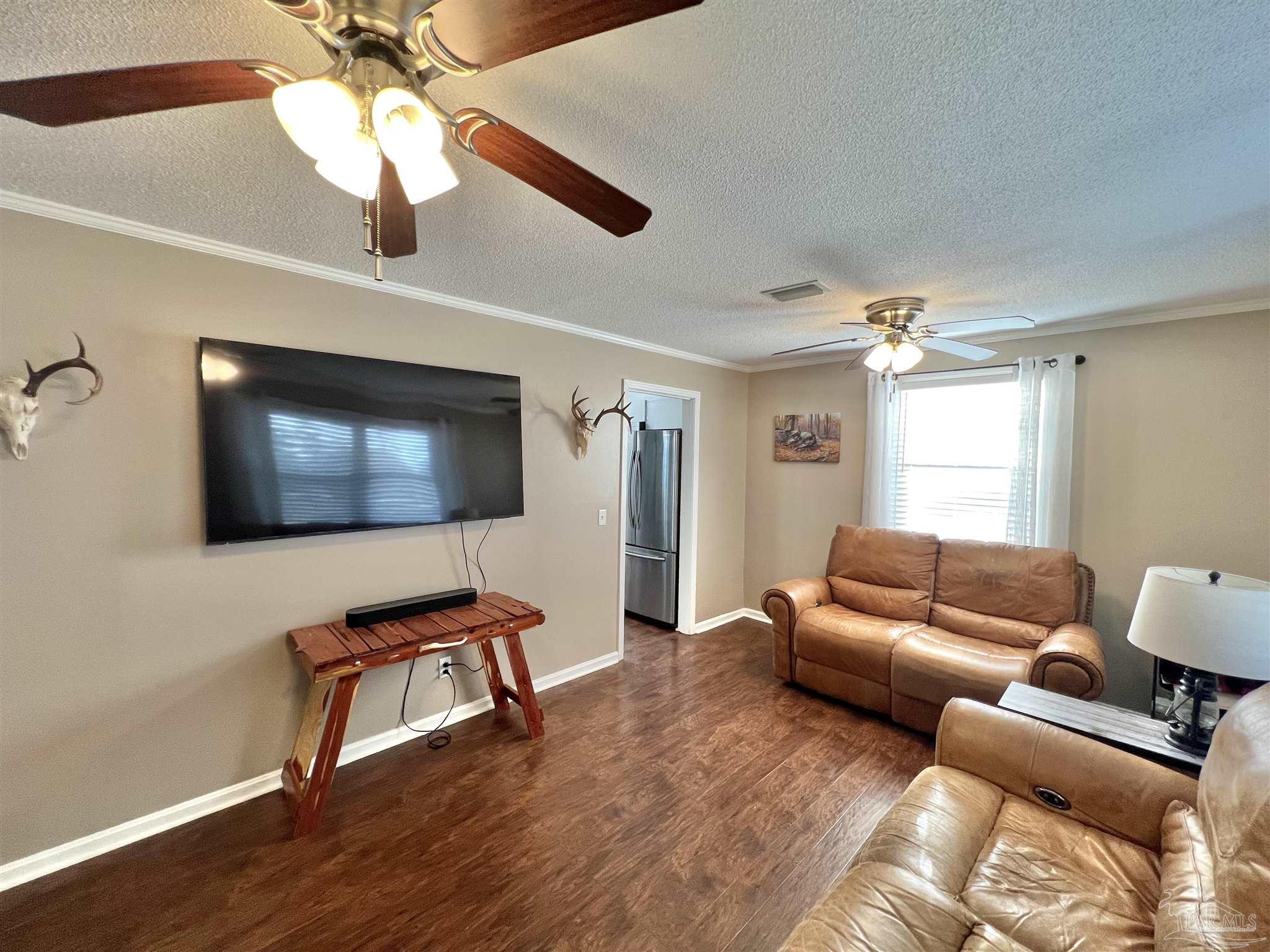 4075 Macks Road Century, FL 32535 - Photo 22 of 45 a living room with furniture and a flat screen tv