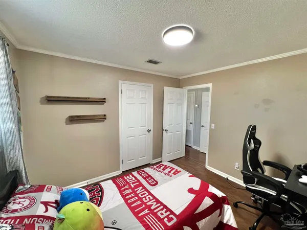 a bedroom with a bed and a dresser