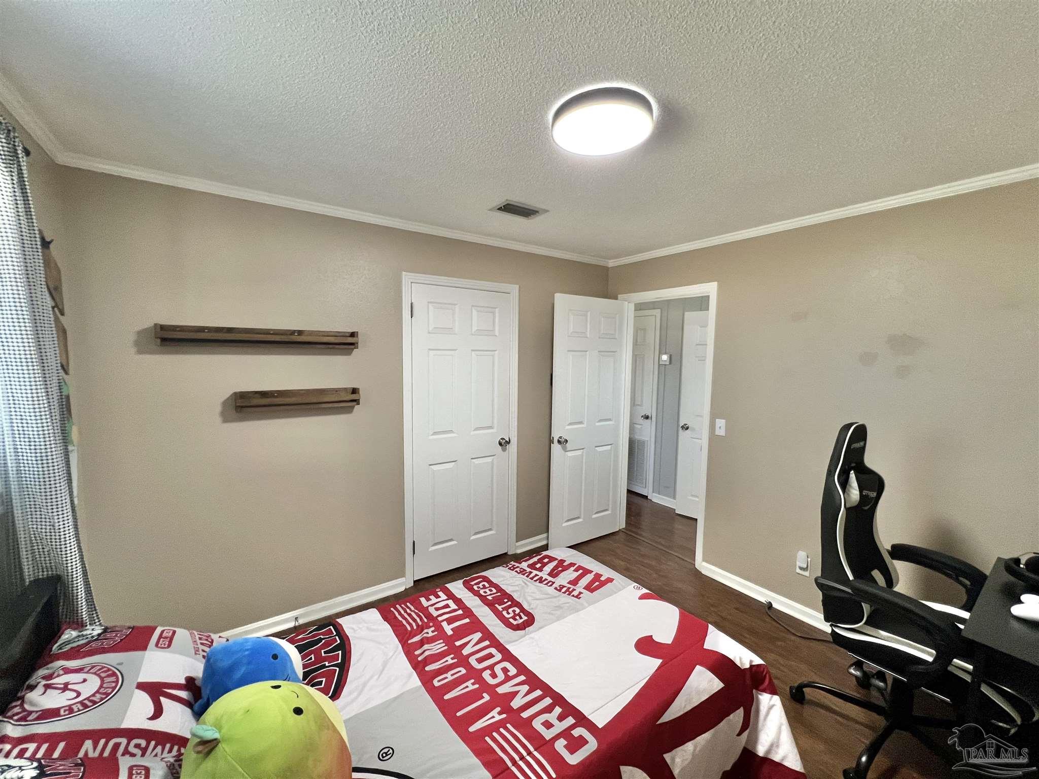 4075 Macks Road Century, FL 32535 - Photo 23 of 45 a bedroom with a bed and a dresser