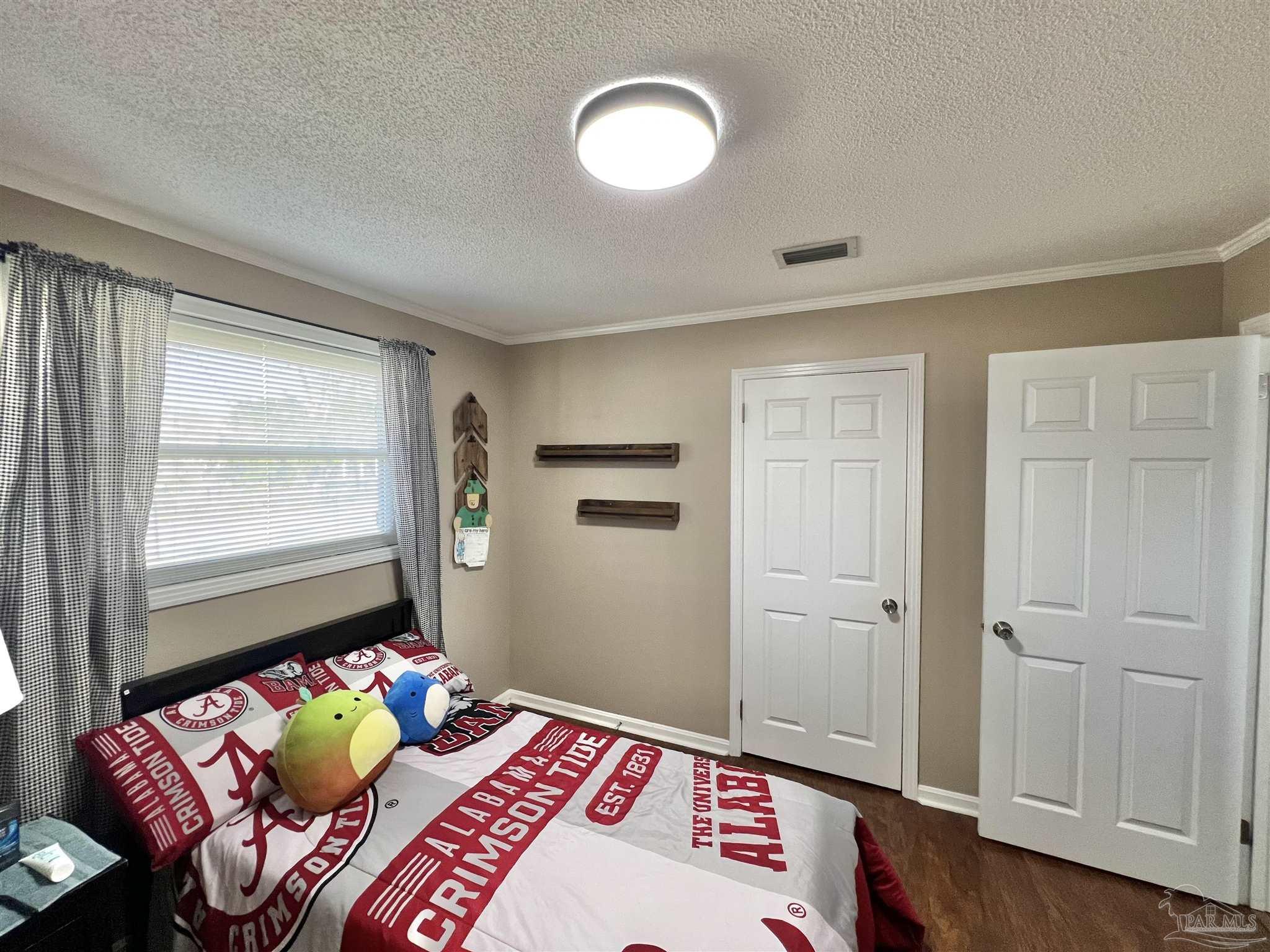 4075 Macks Road Century, FL 32535 - Photo 24 of 45 a bedroom with a bed and a window