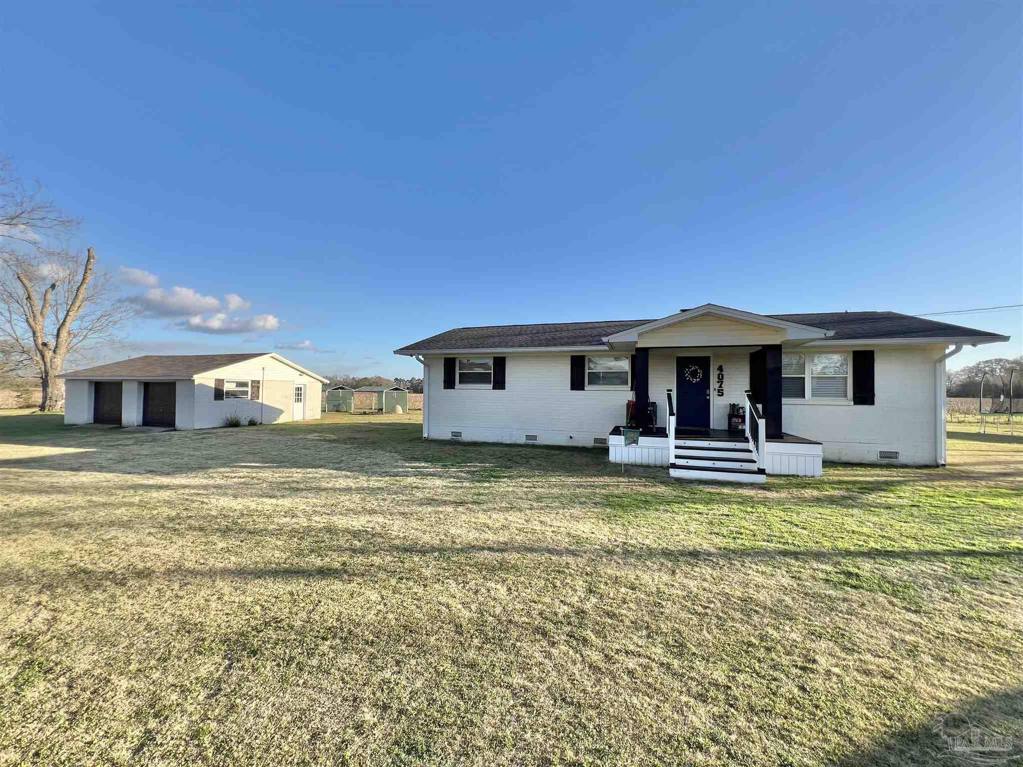 4075 Macks Road Century, FL 32535 - Photo 31 of 45 a view of a house with swimming pool and a yard