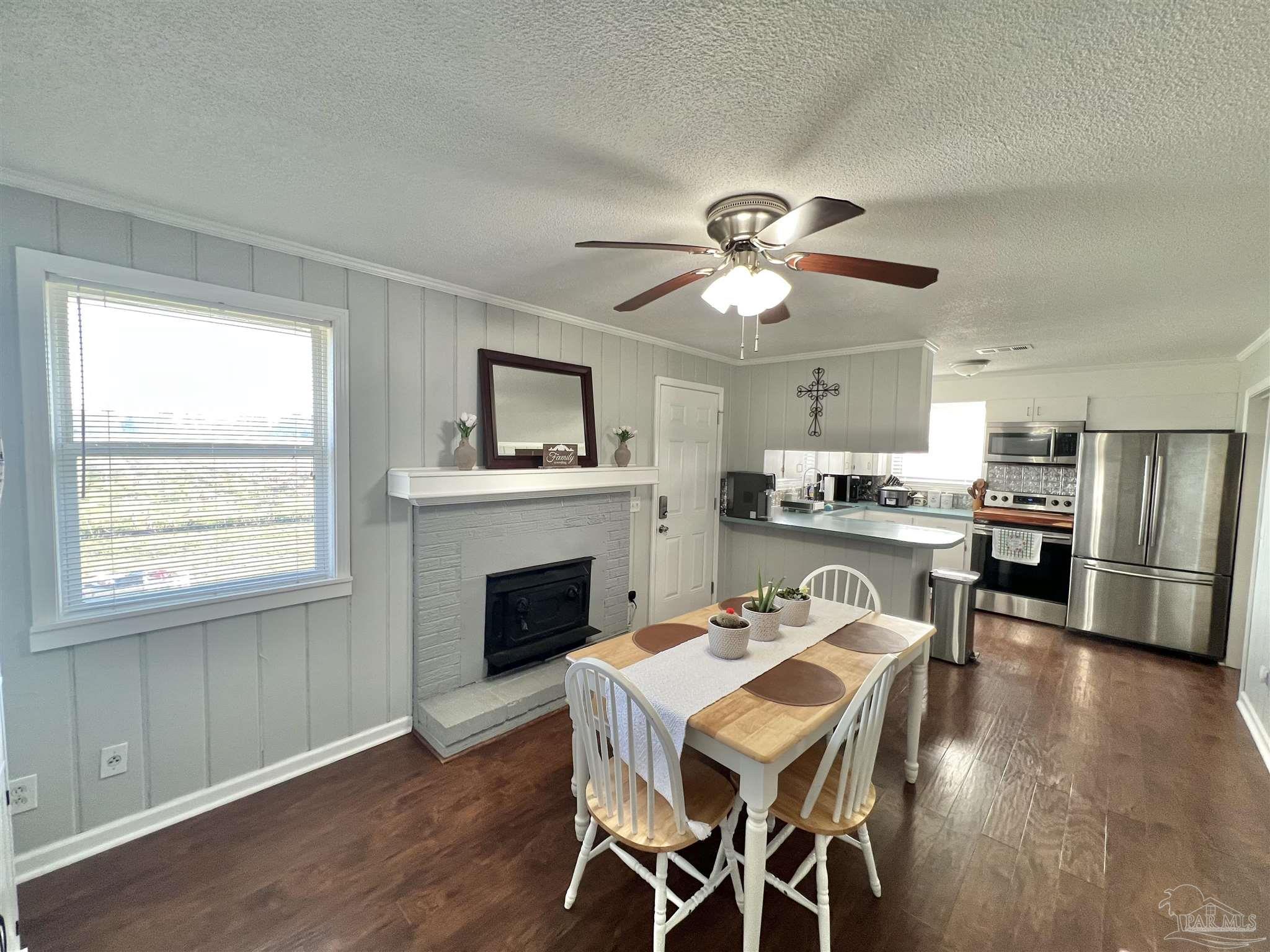 4075 Macks Road Century, FL 32535 - Photo 7 of 45 a view of a dining room with furniture a chandelier and wooden floor