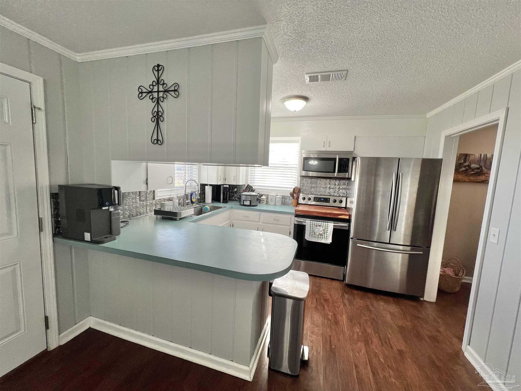4075 Macks Road Century, FL 32535 - Photo 9 of 45 a kitchen with granite countertop a refrigerator stove and sink