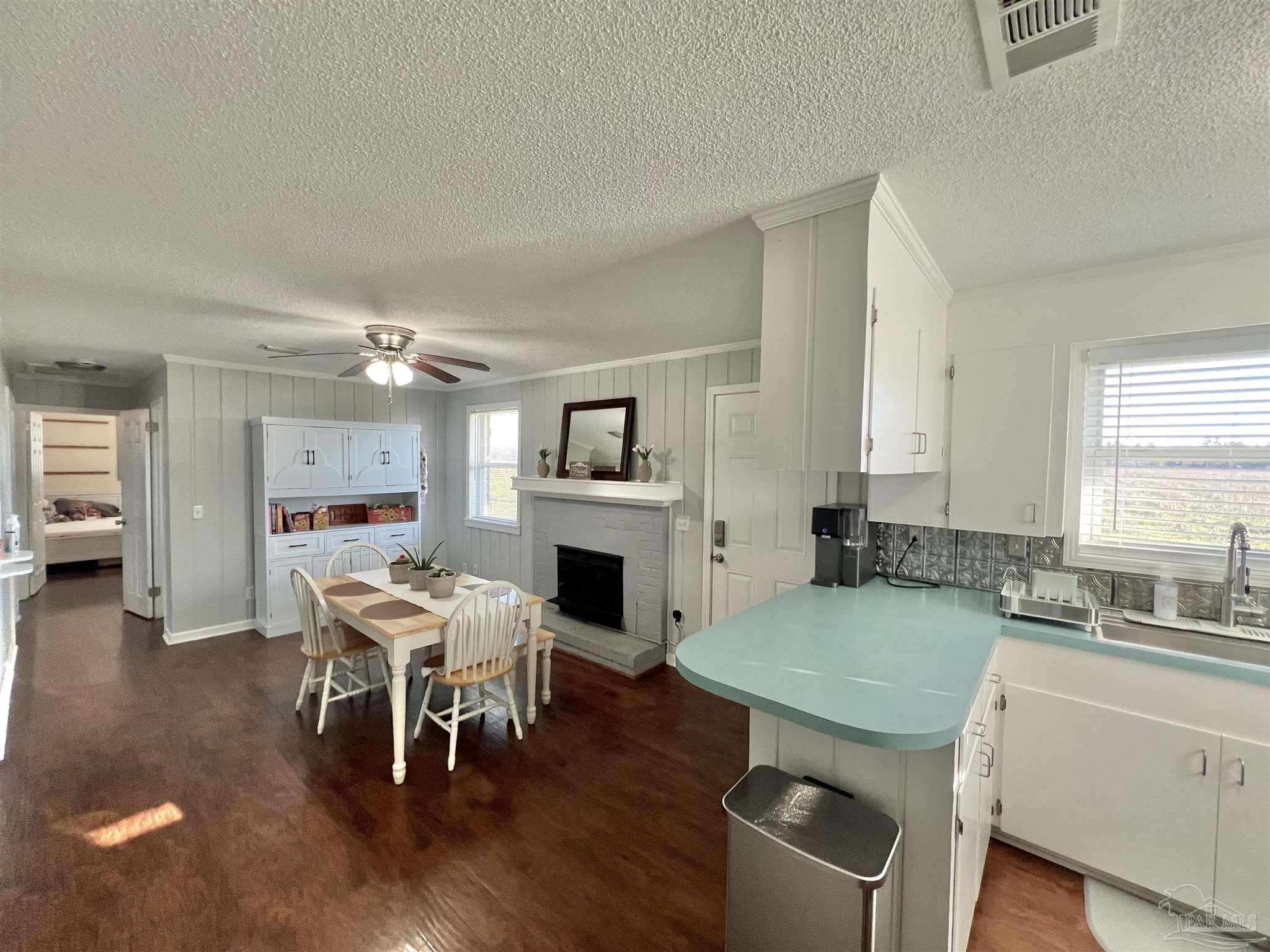 4075 Macks Road Century, FL 32535 - Photo 10 of 45 a living room with furniture wooden floor and a fireplace