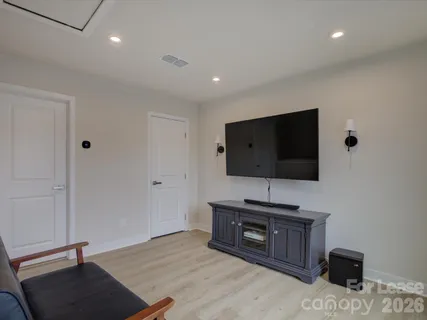 a bathroom with a granite countertop toilet sink and mirror