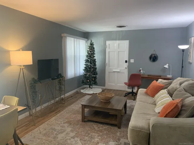 a living room with furniture and a flat screen tv