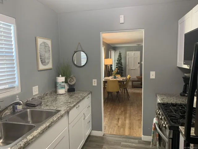 a kitchen with sink and refrigerator