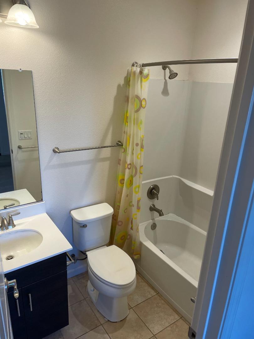 388 Expedition Lane Milpitas, CA 95035 - Photo 8 of 18 a bathroom with a sink a toilet a mirror a bathtub and shower