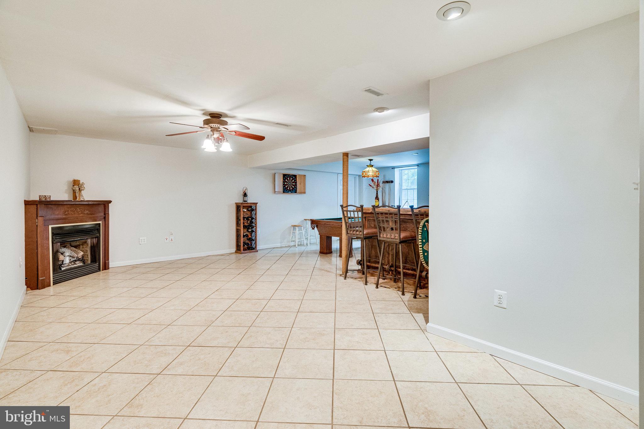 13221 Wates Spring Place Clifton, VA 20124 - Photo 31 of 68 Lower Level Rec Room, huge and tiled and w/gas f/p