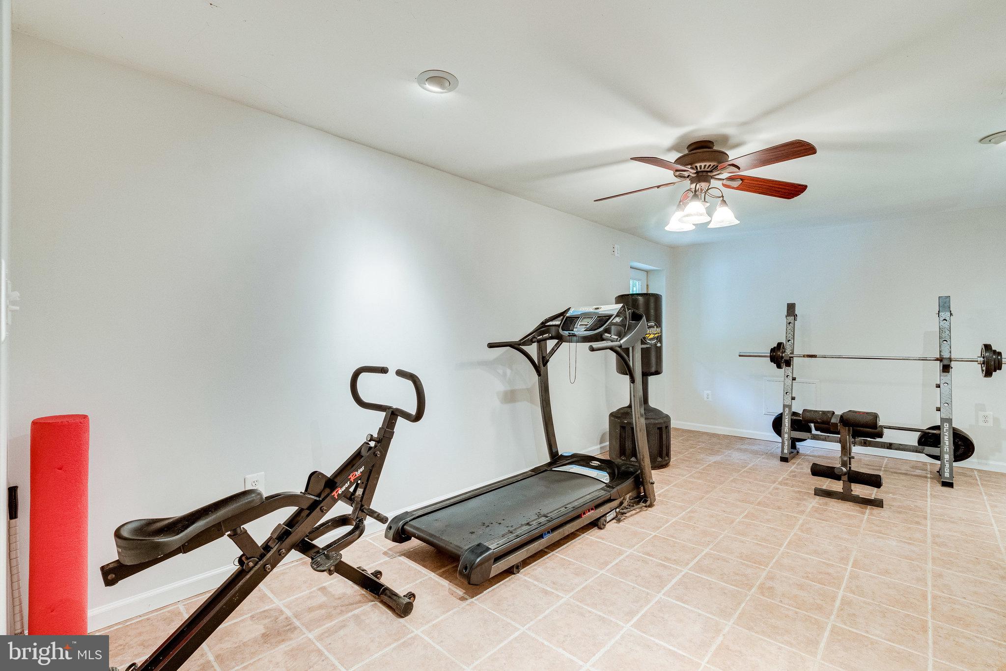 13221 Wates Spring Place Clifton, VA 20124 - Photo 37 of 68 Lower Level Den/Gym w/tile floor to bath from pool