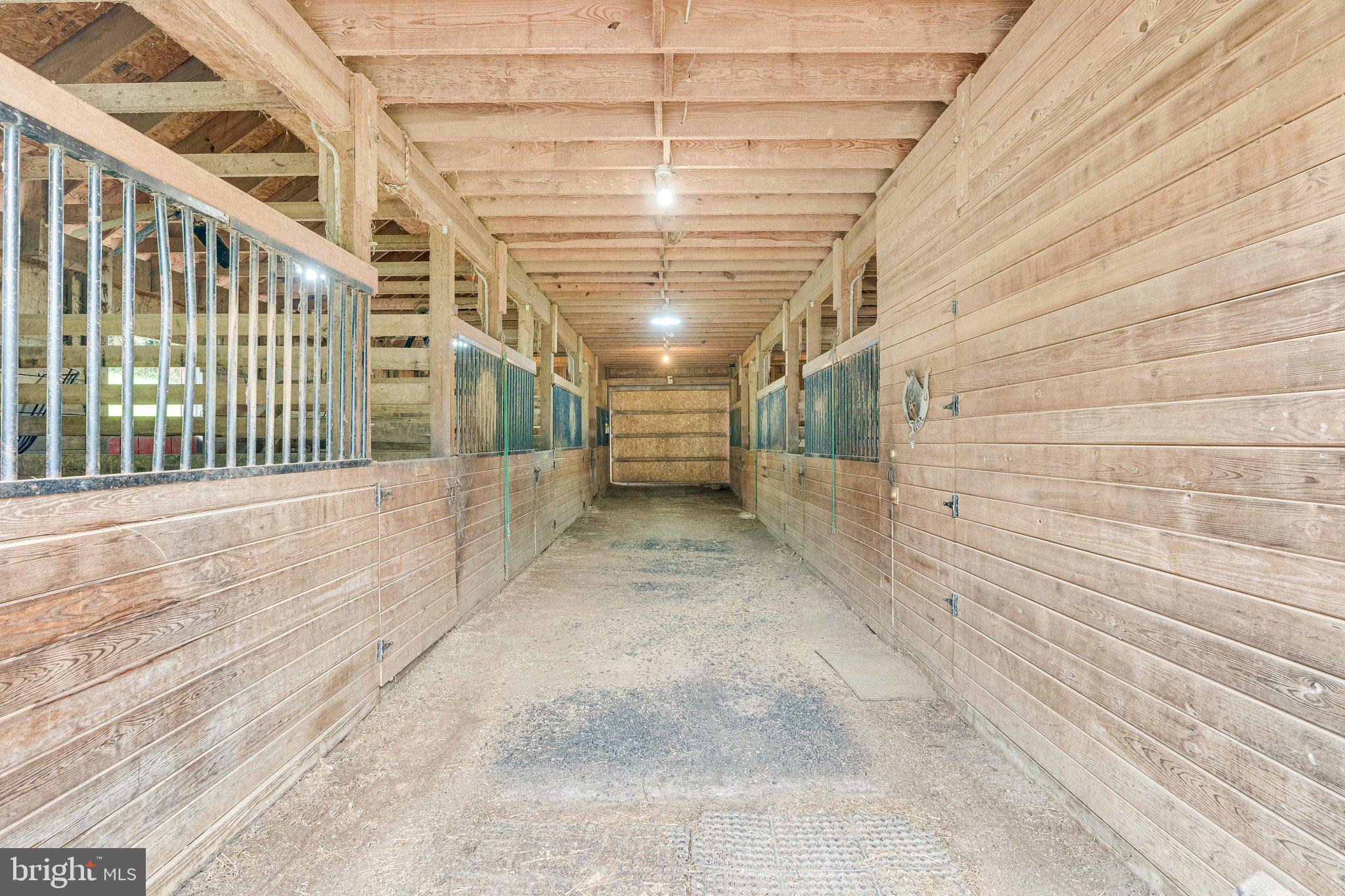 13221 Wates Spring Place Clifton, VA 20124 - Photo 58 of 68 Center Aisle of 7-stall Barn