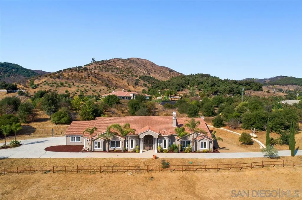 an aerial view of a house with a mountain view