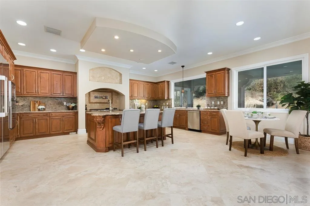 28310 Vía Santa Rosa Temecula, CA 92590 - Photo 13 of 23 a open kitchen with lot of cabinets a sink a dining table and chairs