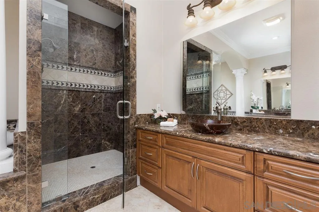 28310 Vía Santa Rosa Temecula, CA 92590 - Photo 19 of 23 a bathroom with a granite countertop sink mirror and bathtub