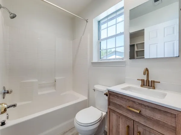 a bathroom with a sink a toilet and a bathtub