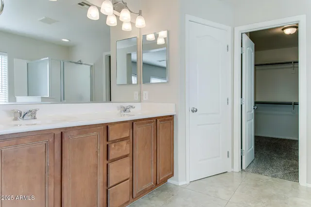 a bathroom with a double vanity sink and a mirror
