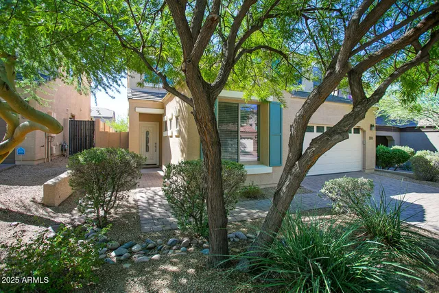 a view of a house with a tree in a yard