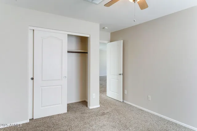 an empty room with windows and cabinet