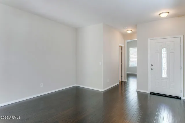 an empty room with wooden floor