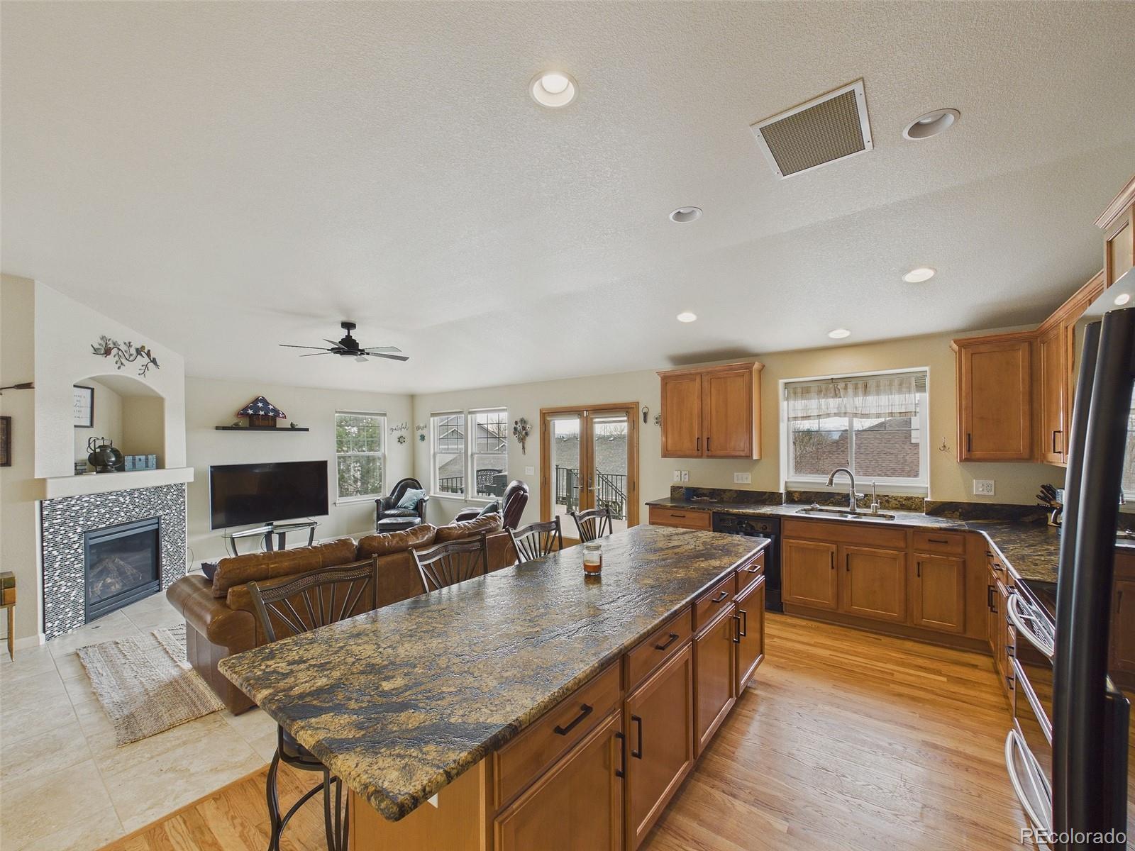 2805 South Jebel Way Aurora, CO 80013 - Photo 18 of 50 a large kitchen with a table and chairs in it