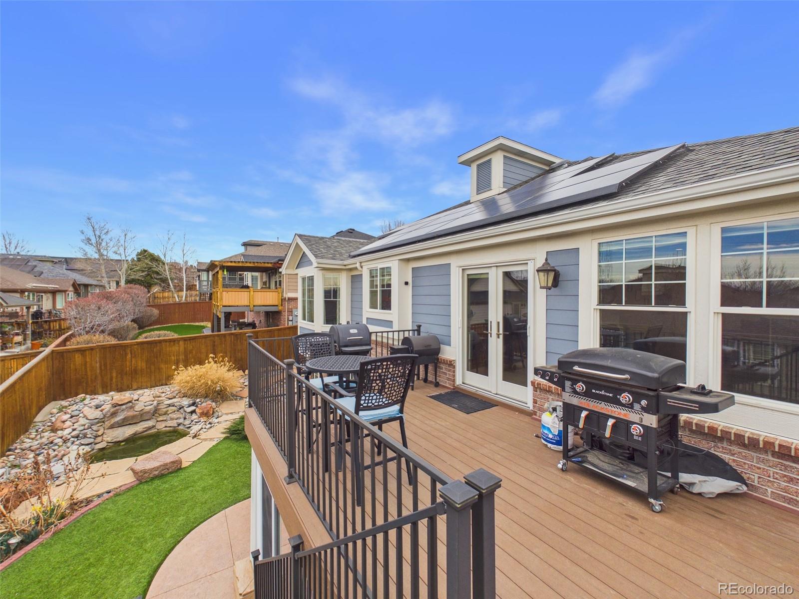 2805 South Jebel Way Aurora, CO 80013 - Photo 24 of 50 a view of a patio with table and chairs with wooden floor and fence