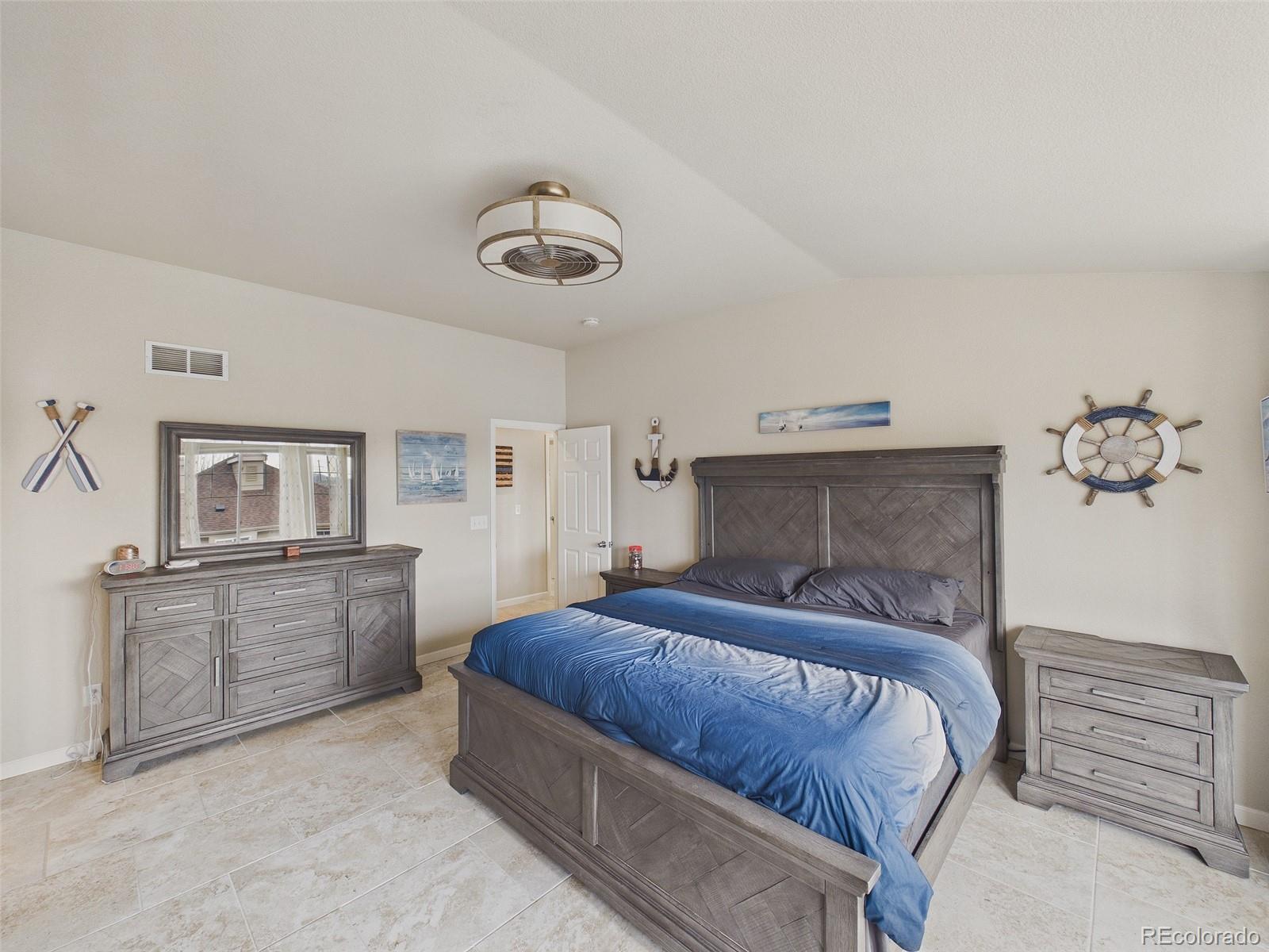 2805 South Jebel Way Aurora, CO 80013 - Photo 27 of 50 a bedroom with a bed and cabinets