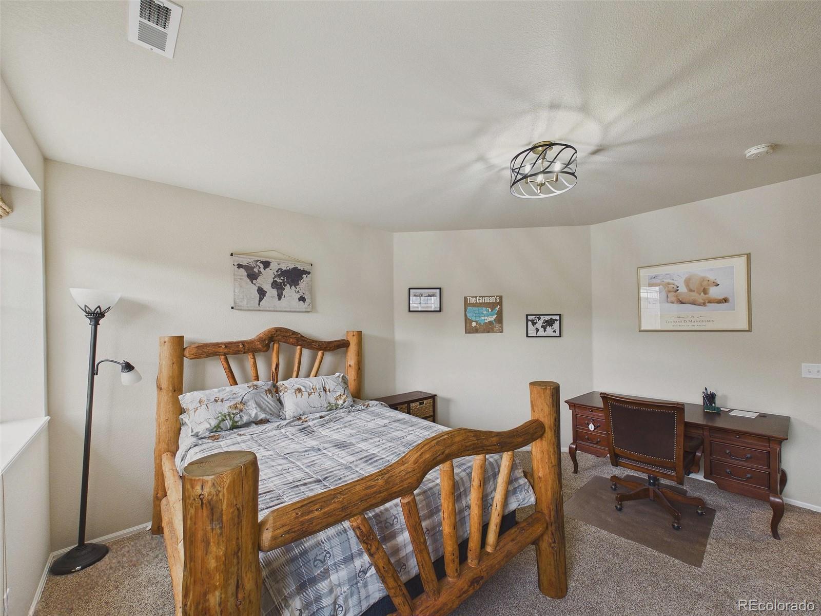 2805 South Jebel Way Aurora, CO 80013 - Photo 44 of 50 a bedroom with a bed and a desk
