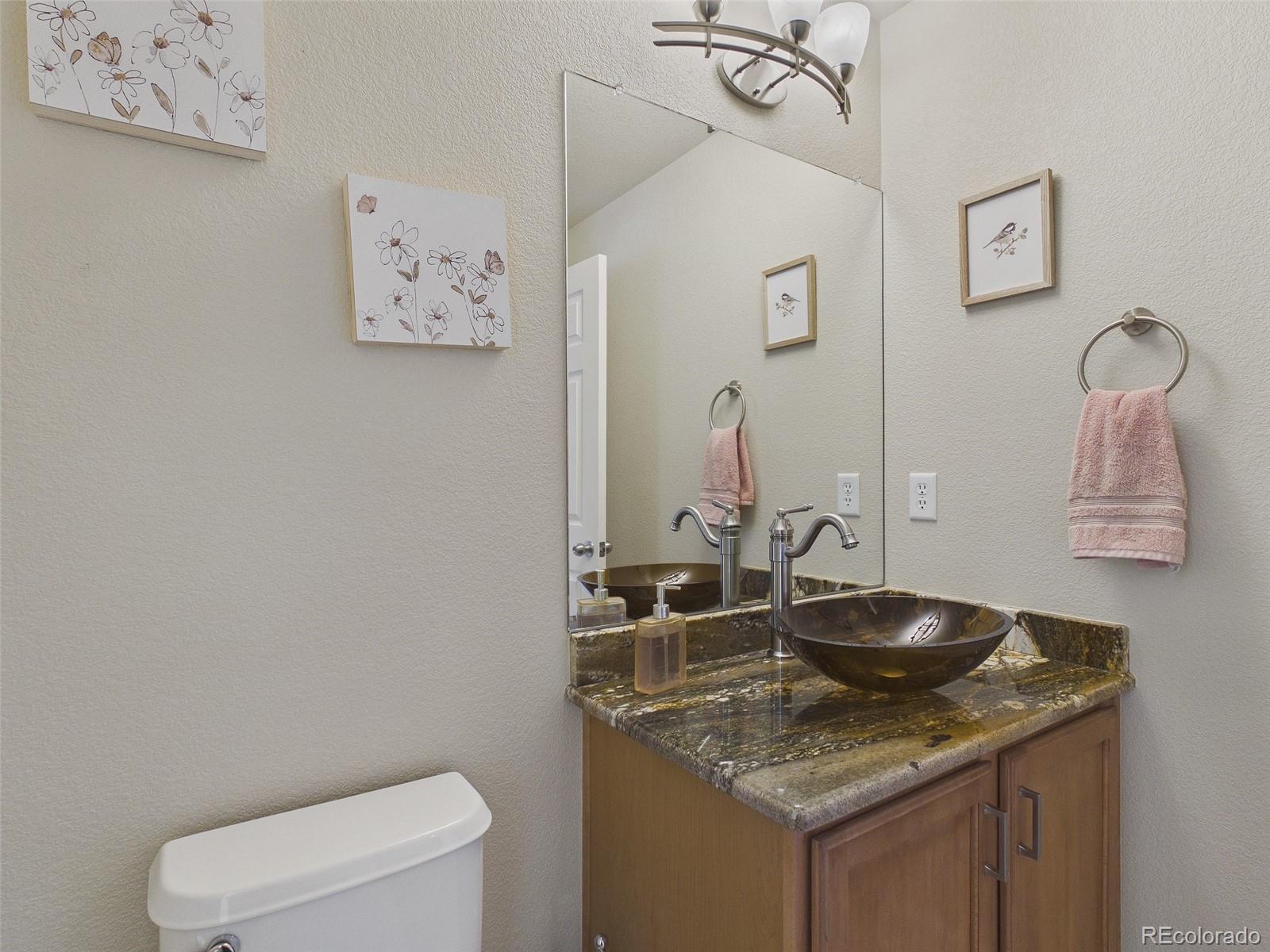 2805 South Jebel Way Aurora, CO 80013 - Photo 6 of 50 a bathroom with a granite countertop sink and a toilet