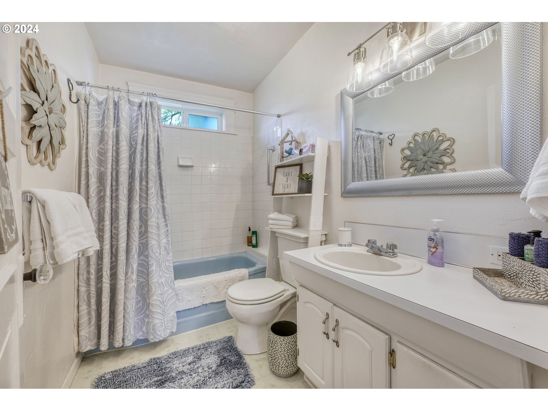343 5th Street Springfield, OR 97477 - Photo 16 of 28 a bathroom with a sink toilet a mirror a vanity and shower