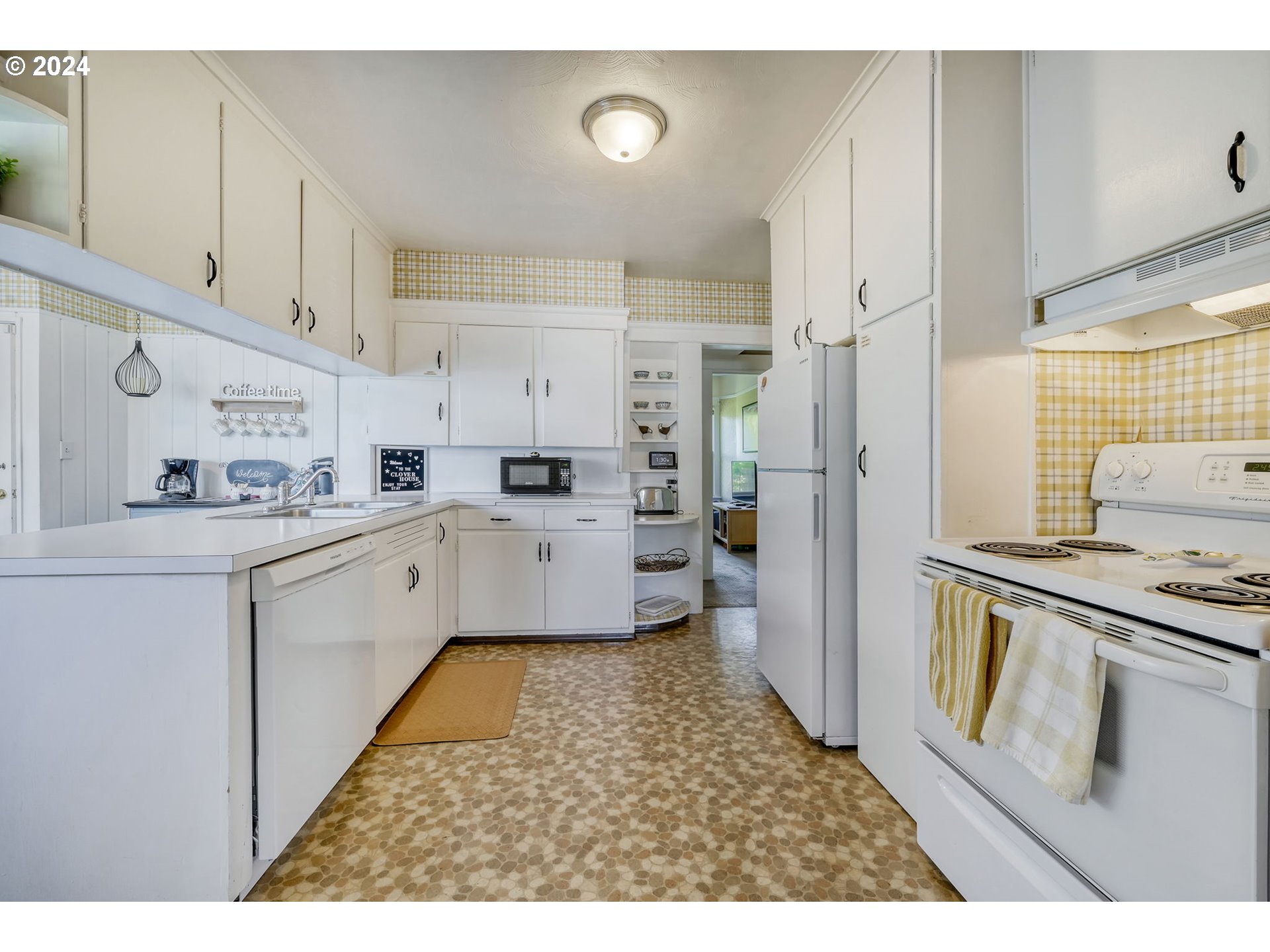 343 5th Street Springfield, OR 97477 - Photo 8 of 28 a kitchen with white cabinets and white appliances