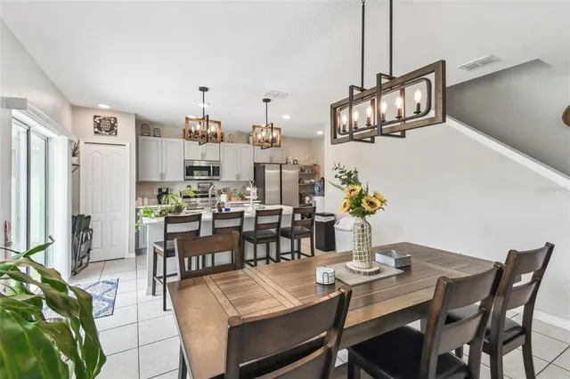 a kitchen with a sink and chairs
