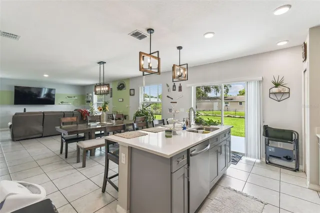 a room with a sink and chandelier