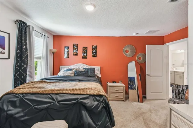 a view of a hallway with a livingroom and a bathroom