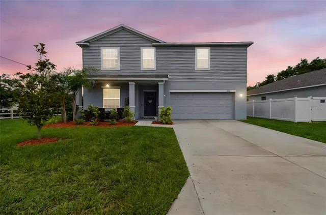 a aerial view of a house with swimming pool and a yard