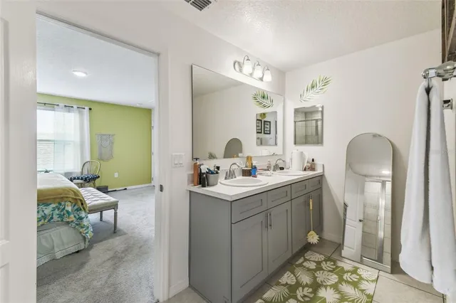 a bathroom with a glass shower door and mirror