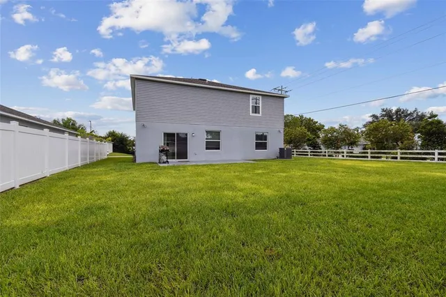 a view of a house with a yard and sitting area