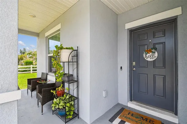 a view of a livingroom with furniture and a hallway