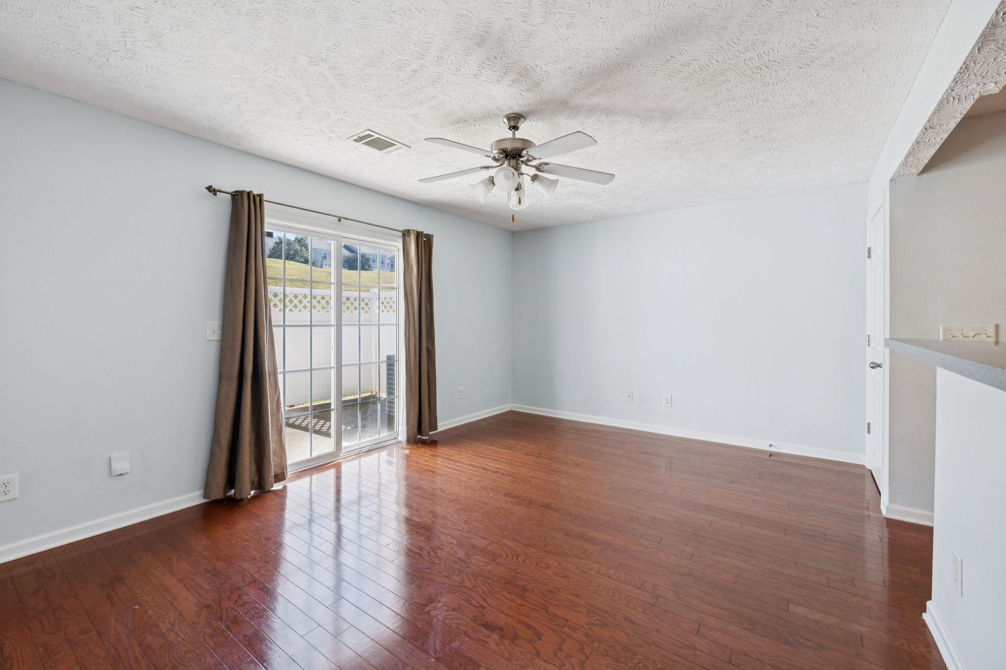 1841 Shaylin Loop Antioch, TN 37013 - Photo 14 of 27 an empty room with wooden floor fan and windows