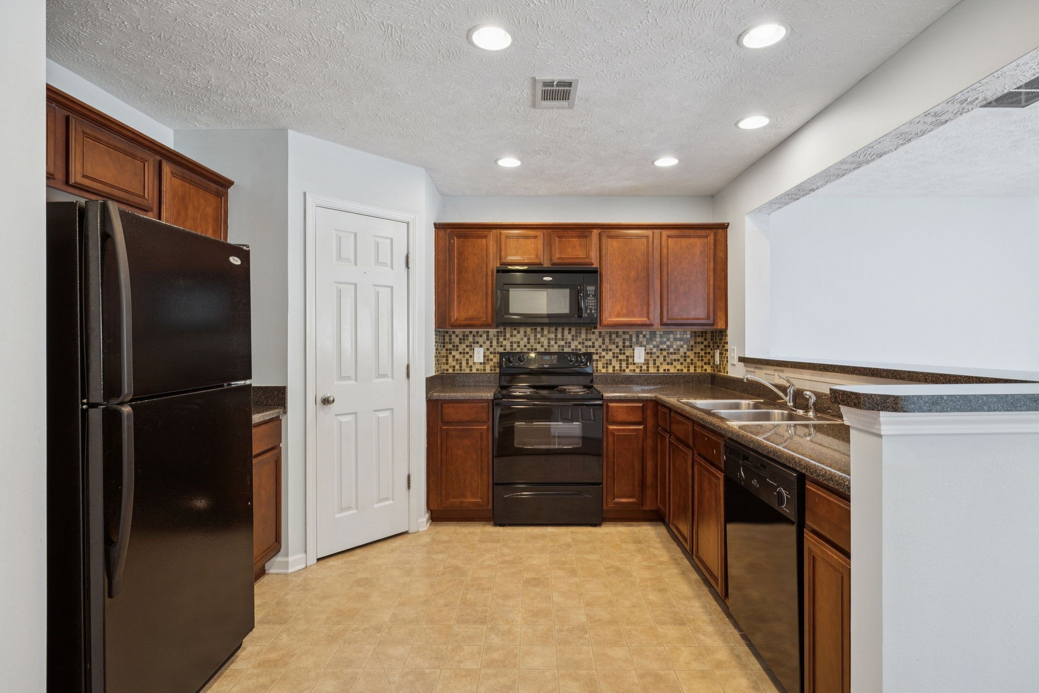 1841 Shaylin Loop Antioch, TN 37013 - Photo 8 of 27 a kitchen with stainless steel appliances granite countertop a refrigerator a stove and a sink