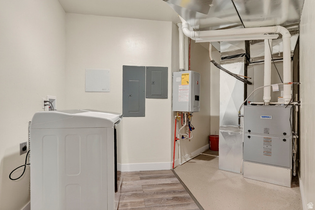 3311 West Allard Summit, UT 84772 - Photo 71 of 97 Utility area featuring a top-load washing machine, wood-finish flooring, two electrical panels, a tankless water heater, and a furnace system