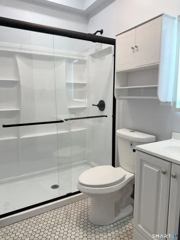 a bathroom with a toilet and a shower