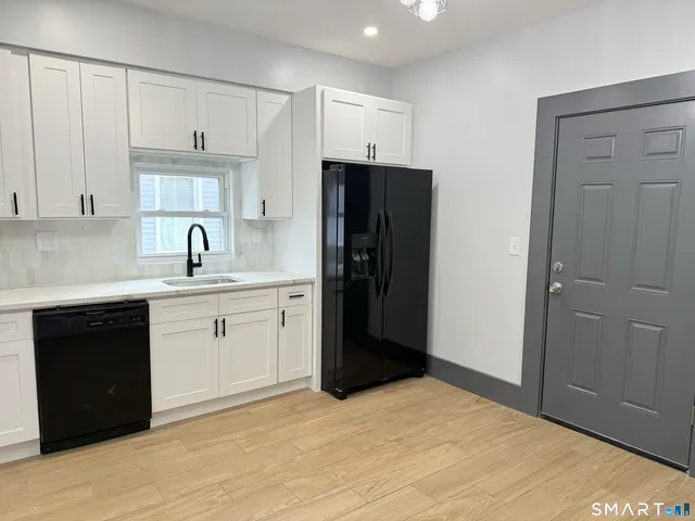 a kitchen with a refrigerator and cabinets