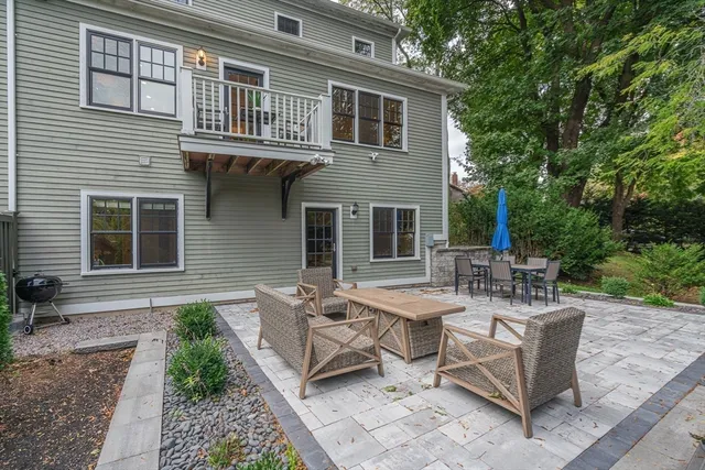 a view of a house with backyard sitting area and garden
