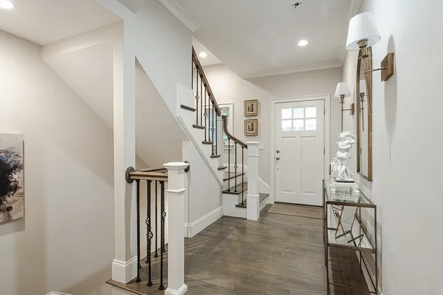 a view of entryway with stairs and wooden floor